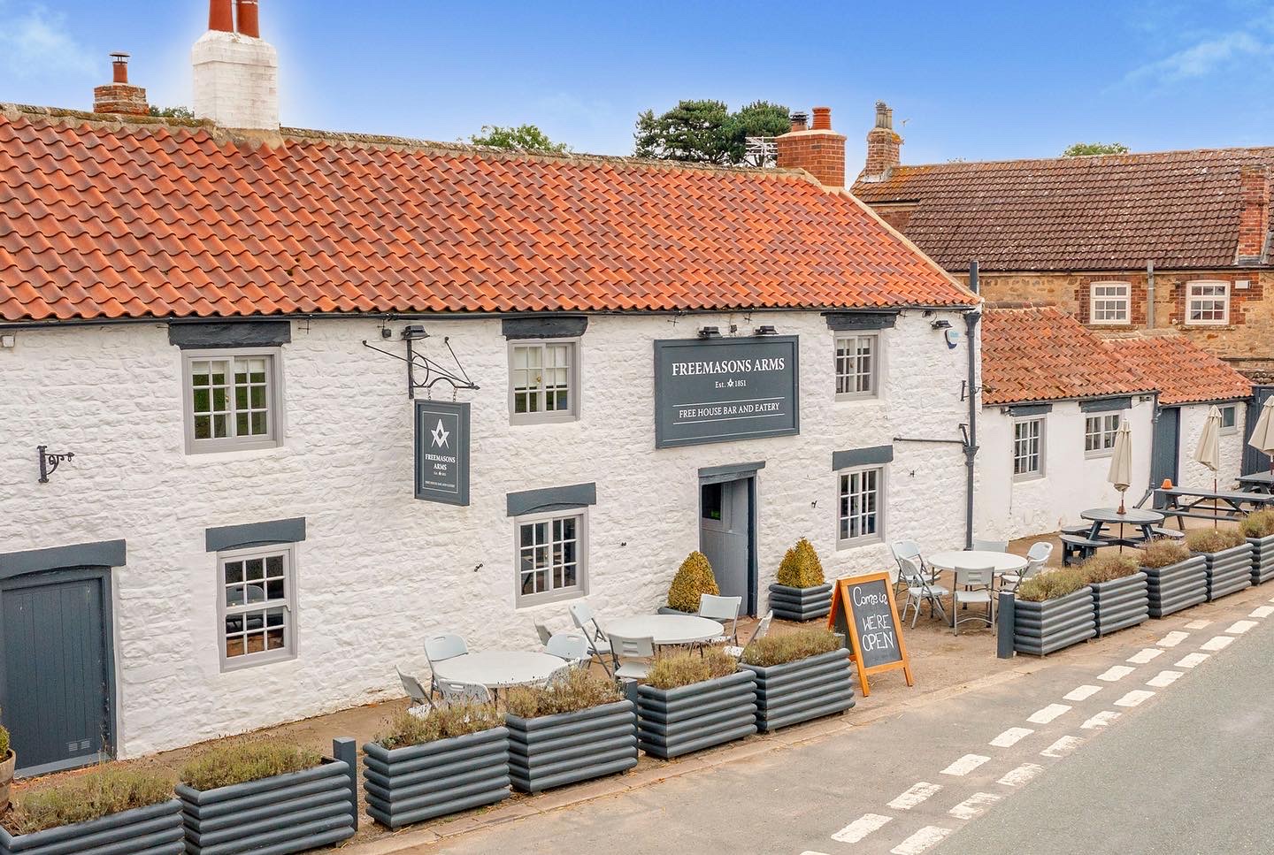 A historic photograph of The Freemasons Arms