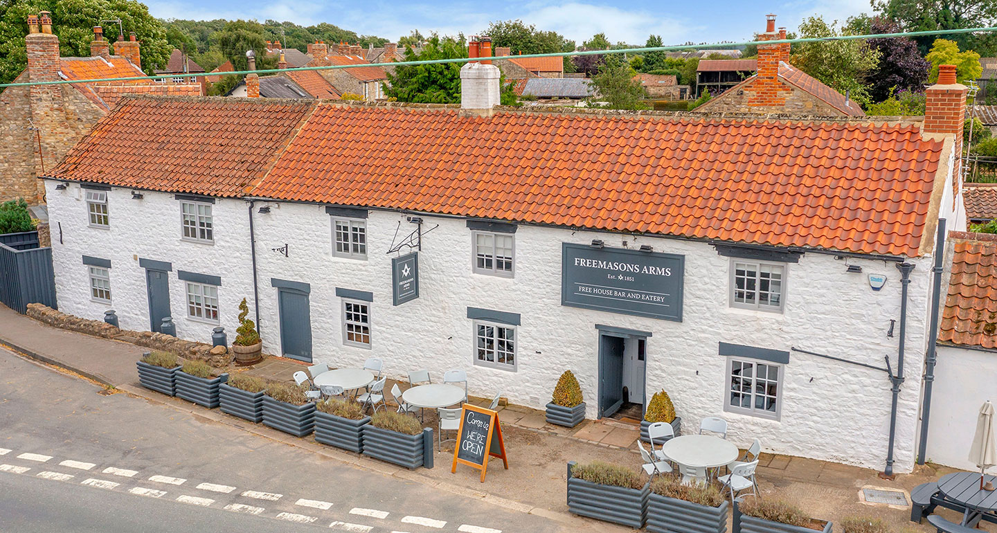 A historic photograph of The Freemasons Arms